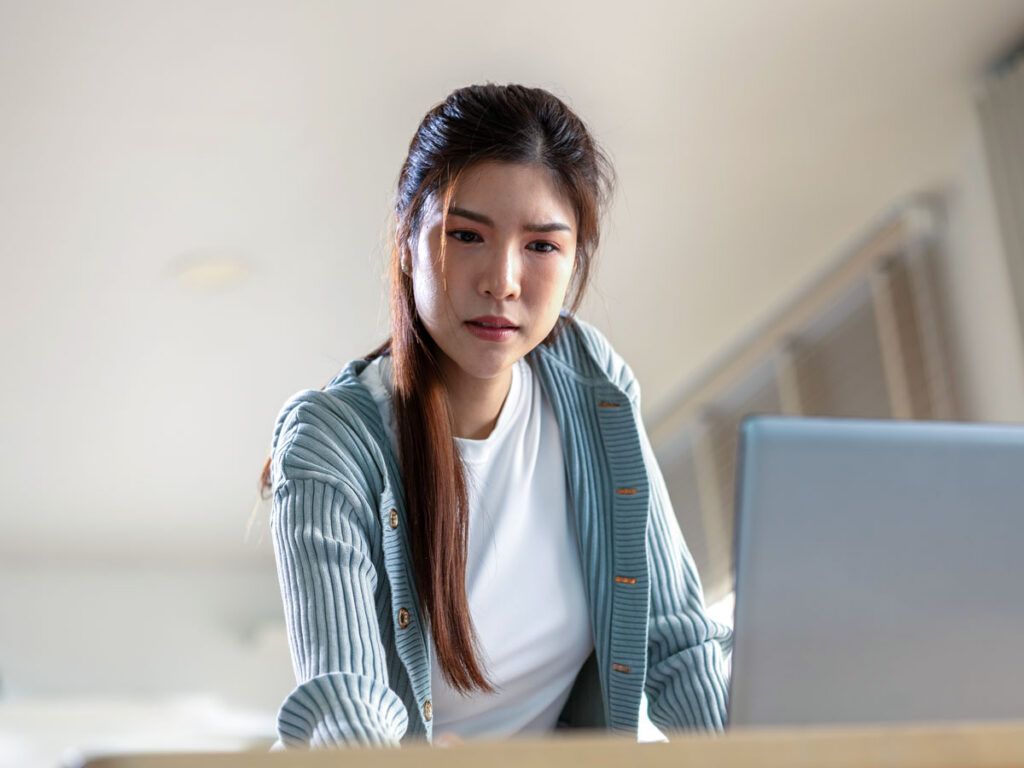 Woman concentrating while looking at her laptop