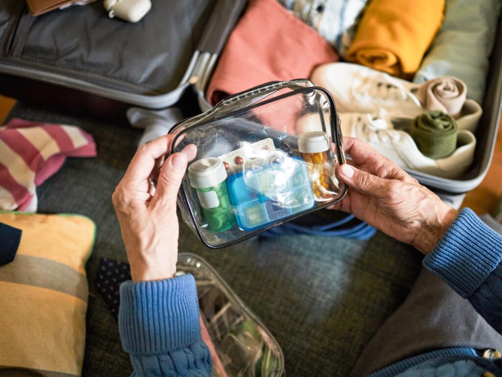Woman packing toiletries in a suitcase