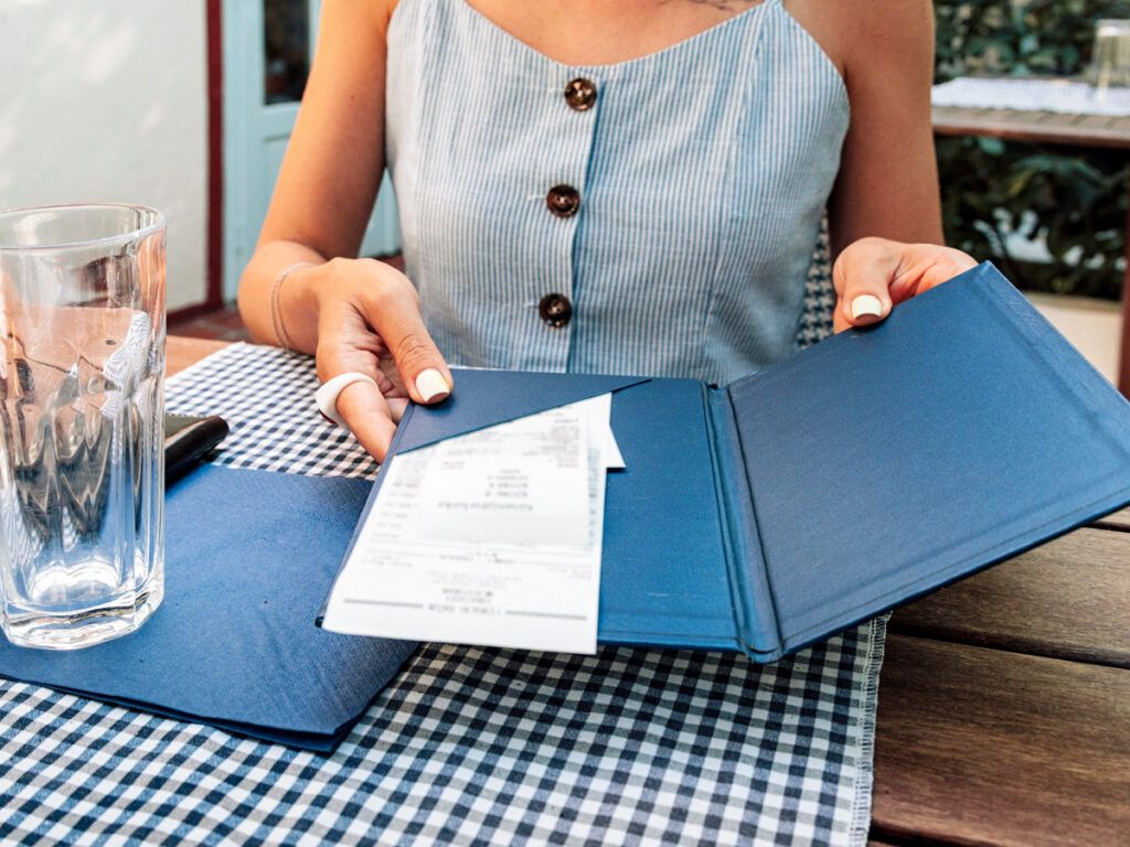 Woman looking at a bill at a restaurant
