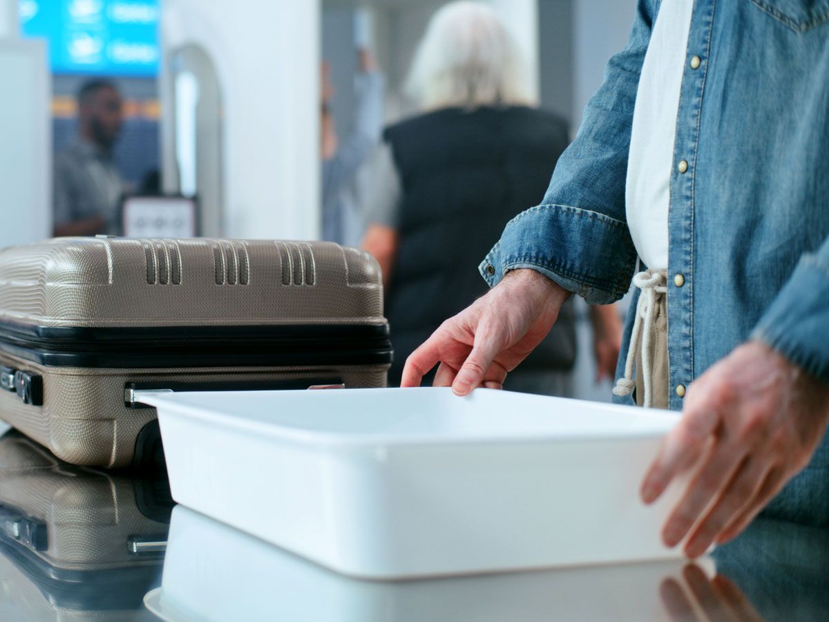 Passenger using bin at security checkpoint