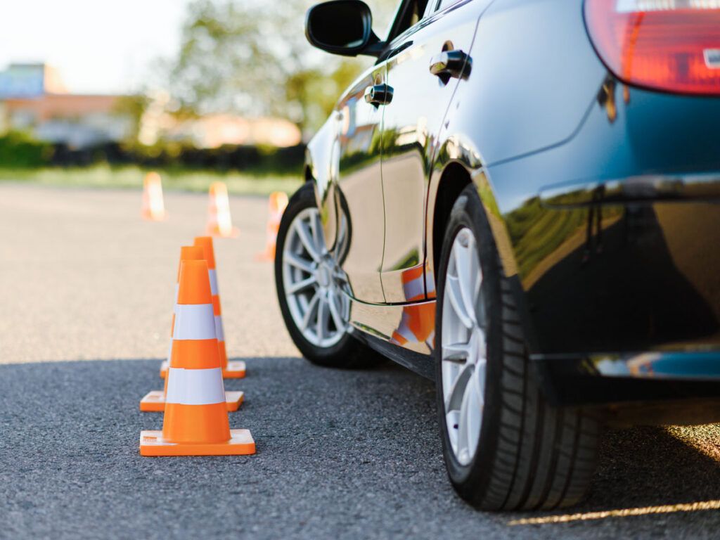 Car driving past traffic cones