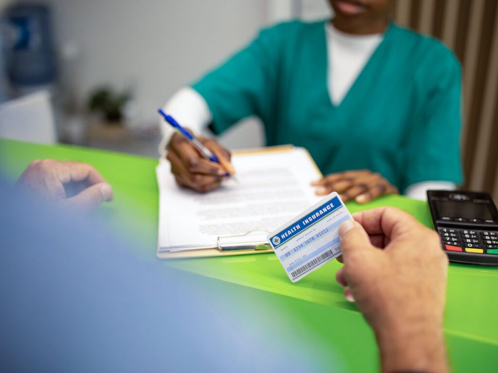 Woman holding a medical insurance card