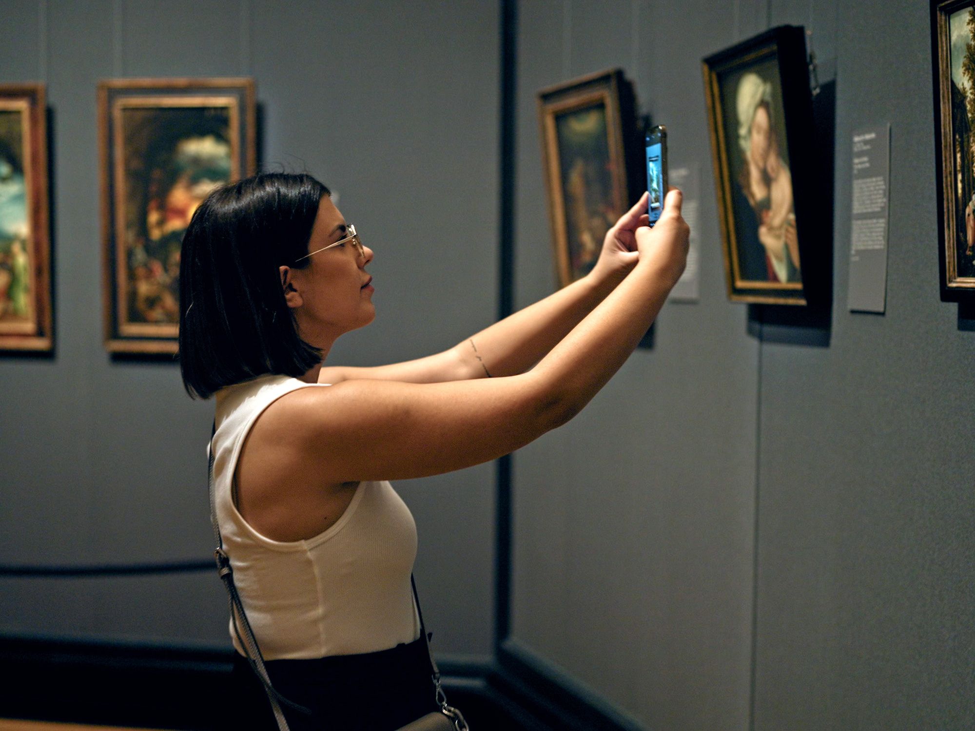 Museum goer taking photo of art