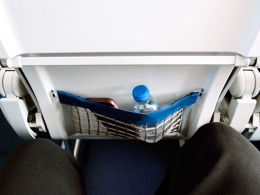 Airplane storage pocket with personal items inside