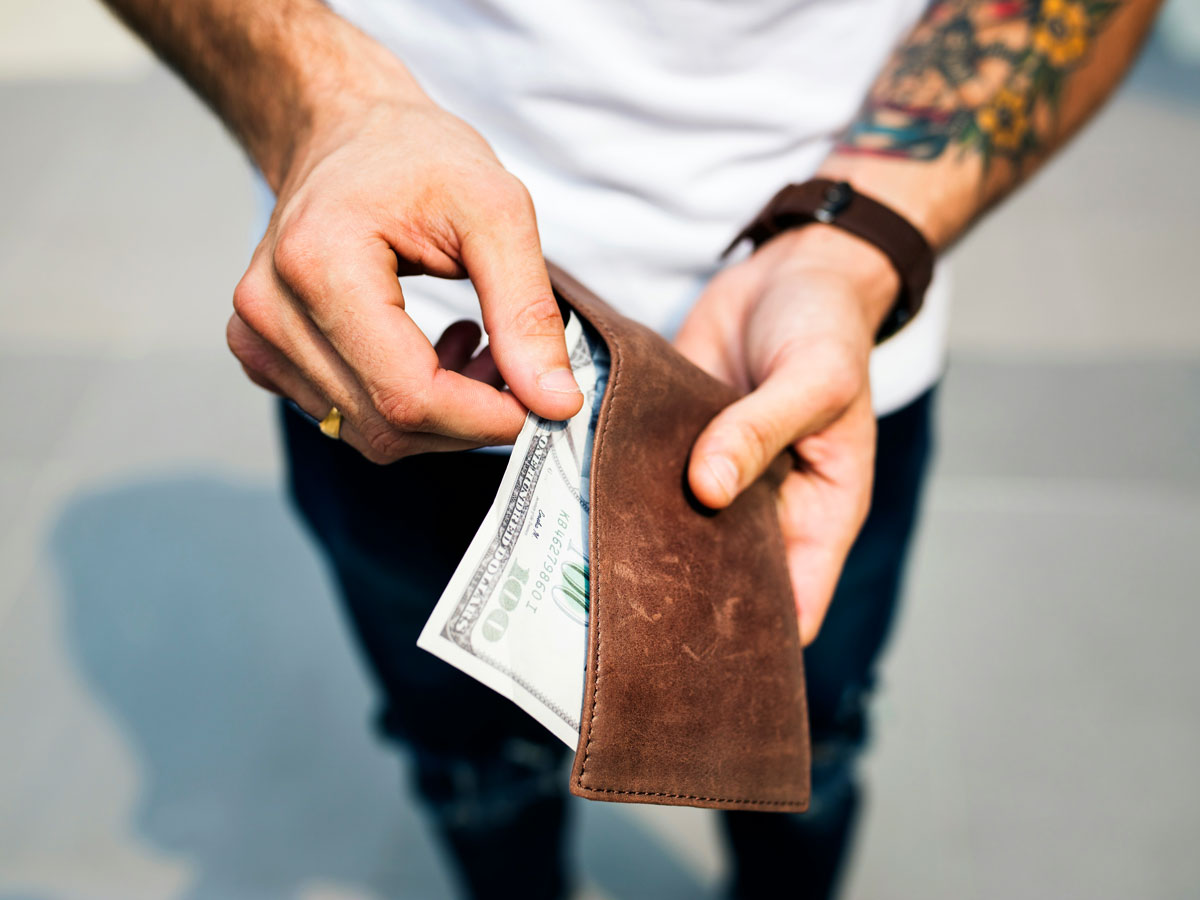 Man pulling money out of his wallet